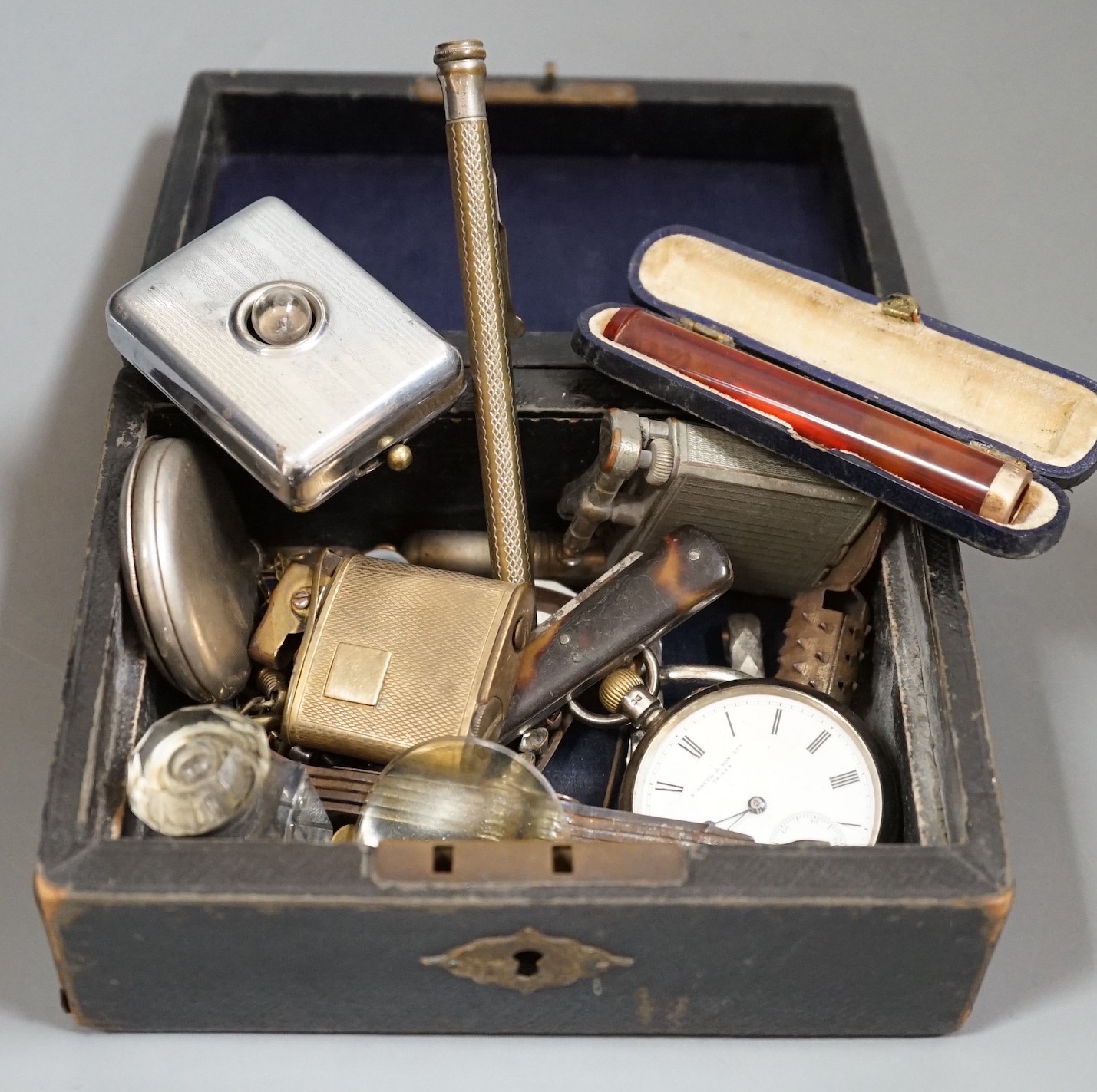 An amber and gilt metal mounted cigarette holder, gilt metal lighter etc